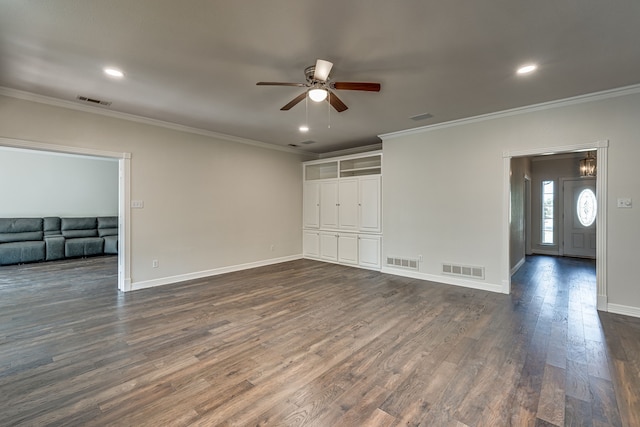 spare room featuring crown molding, dark hardwood / wood-style floors, and ceiling fan