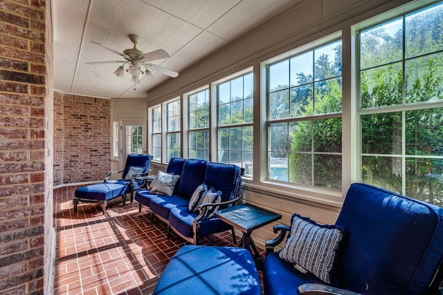 sunroom / solarium featuring a wealth of natural light and ceiling fan