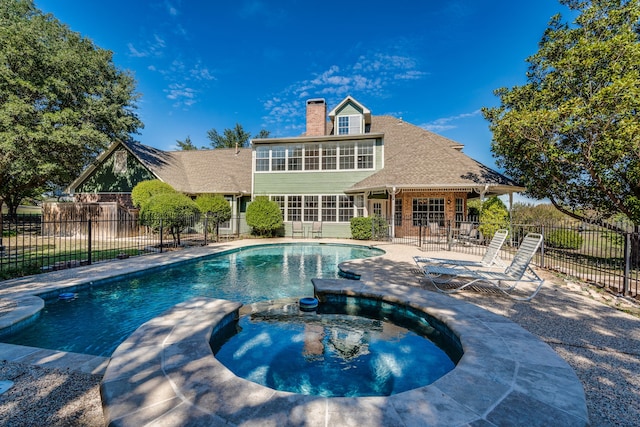 view of pool with a patio and an in ground hot tub