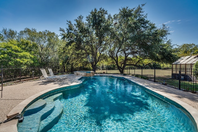 view of swimming pool featuring an in ground hot tub and a patio area