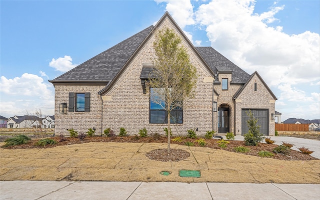 french provincial home with a garage