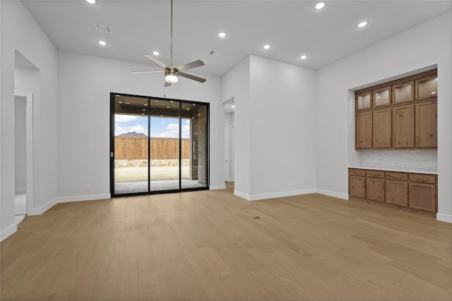 unfurnished living room featuring light hardwood / wood-style floors and ceiling fan