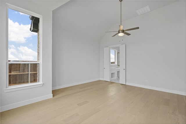 spare room featuring light wood-type flooring, a healthy amount of sunlight, and ceiling fan