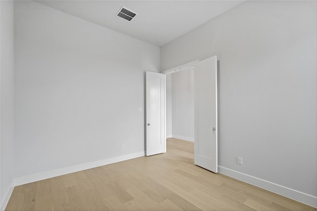 unfurnished room with light hardwood / wood-style flooring