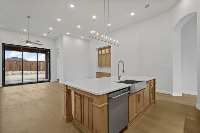 kitchen featuring decorative light fixtures, sink, a large island with sink, and stainless steel dishwasher