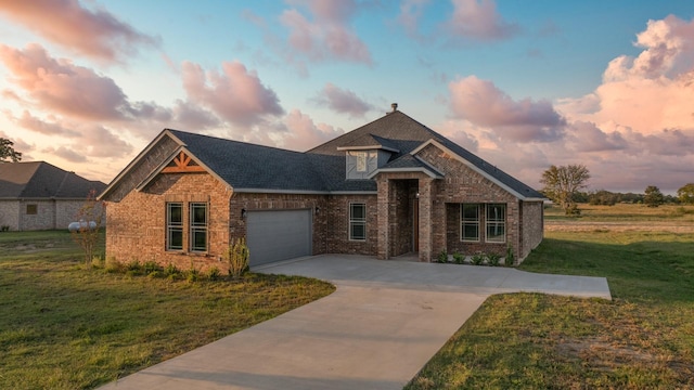 view of front facade with a yard and a garage