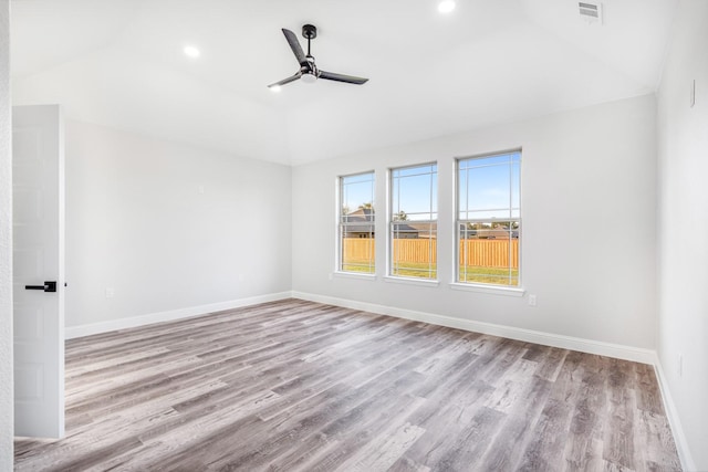 spare room with ceiling fan, light hardwood / wood-style floors, and vaulted ceiling