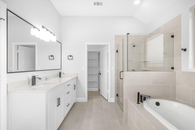 bathroom with independent shower and bath, vanity, tile patterned floors, and lofted ceiling