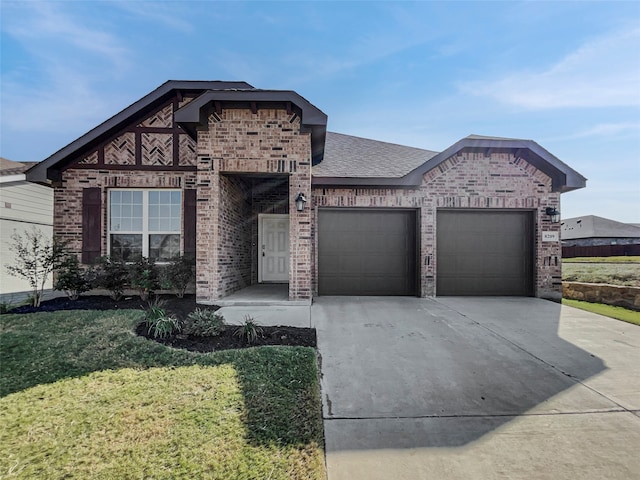 view of front of house with a front yard and a garage