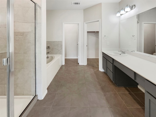 bathroom with vanity, shower with separate bathtub, and tile patterned floors