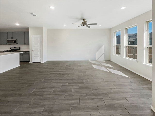 unfurnished living room featuring ceiling fan