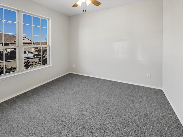 spare room with carpet floors and ceiling fan