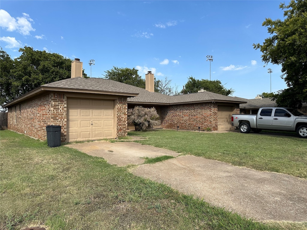 view of front of house with a front lawn and a garage