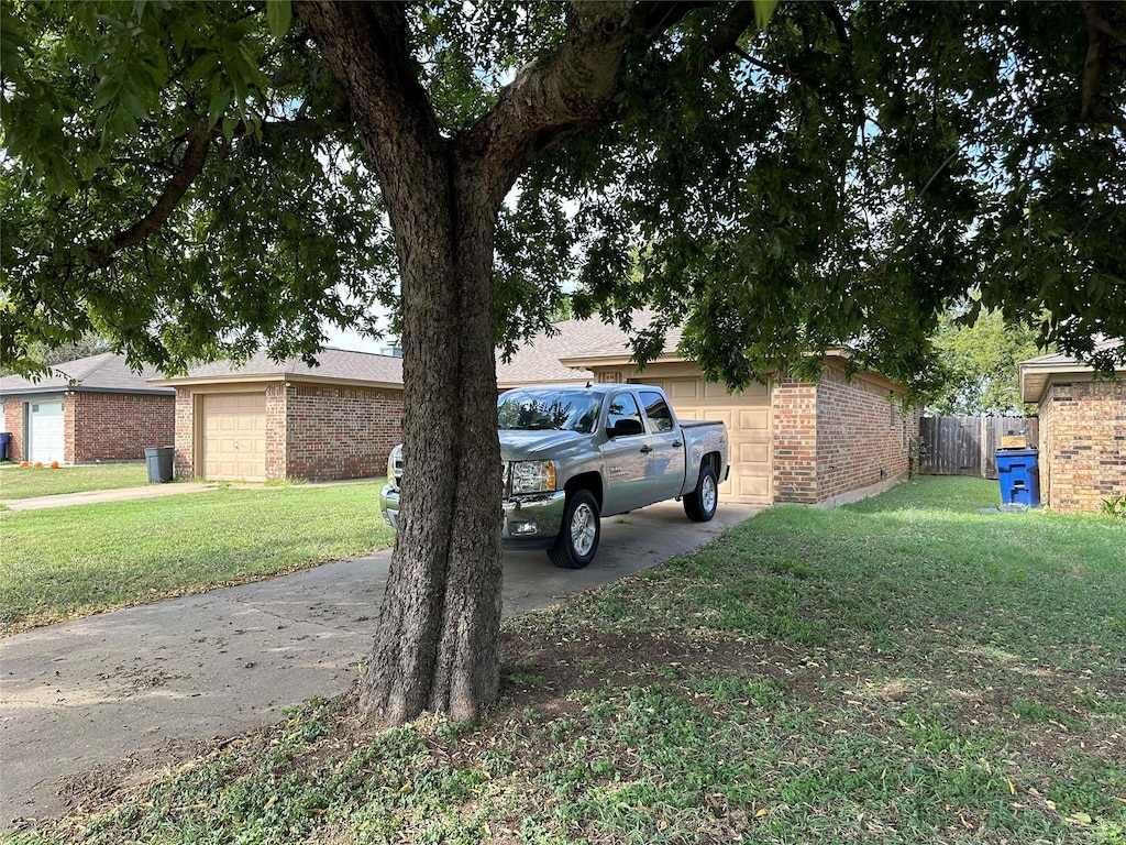 1428 Briar Cir, Crowley, TX 76036 - exterior space with an attached garage, concrete driveway, and fence
