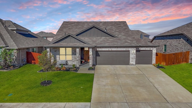 view of front of property with a yard and a garage