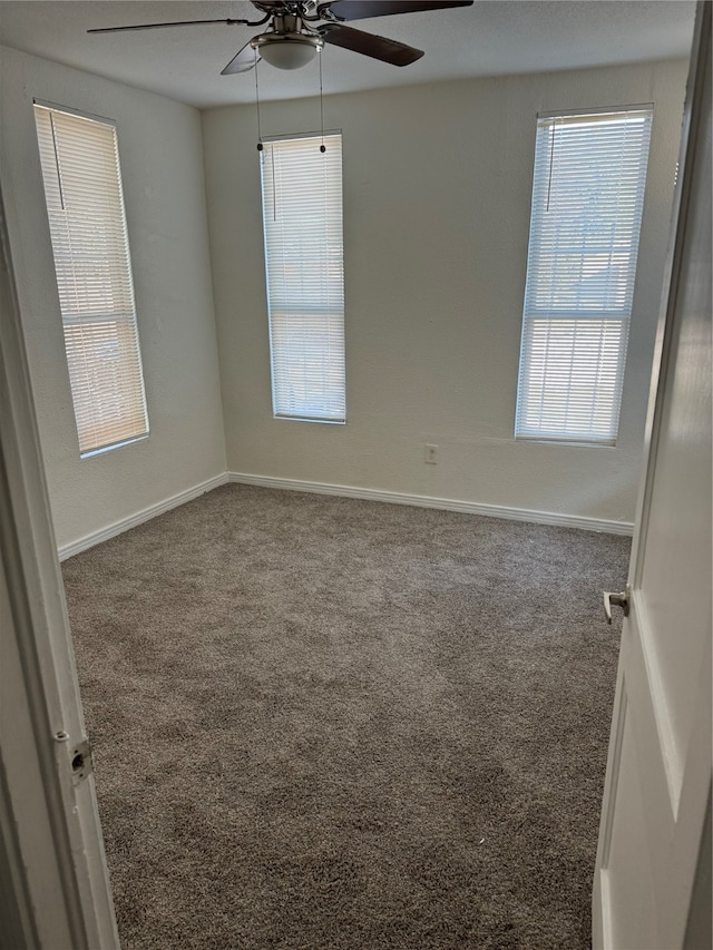 carpeted empty room featuring ceiling fan