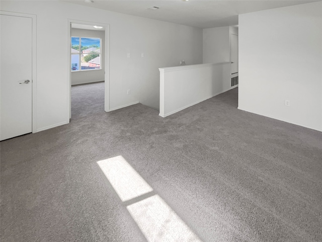 empty room with dark colored carpet