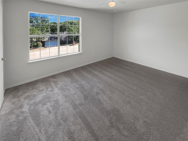 spare room featuring ceiling fan and carpet