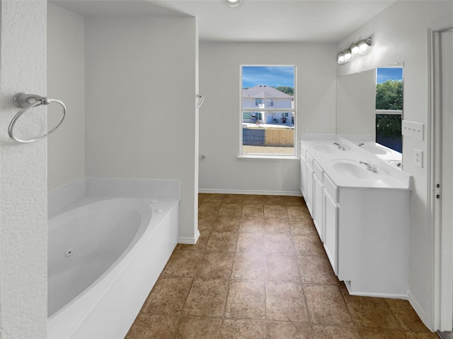 bathroom with vanity and a washtub