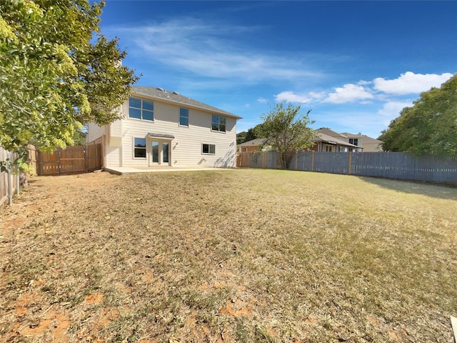 rear view of house featuring a lawn