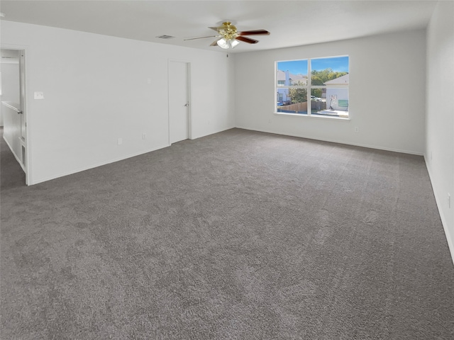 carpeted spare room with ceiling fan