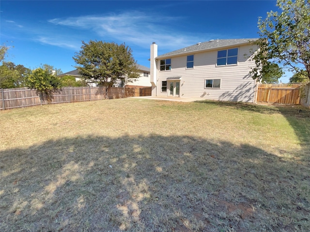 back of house featuring a lawn