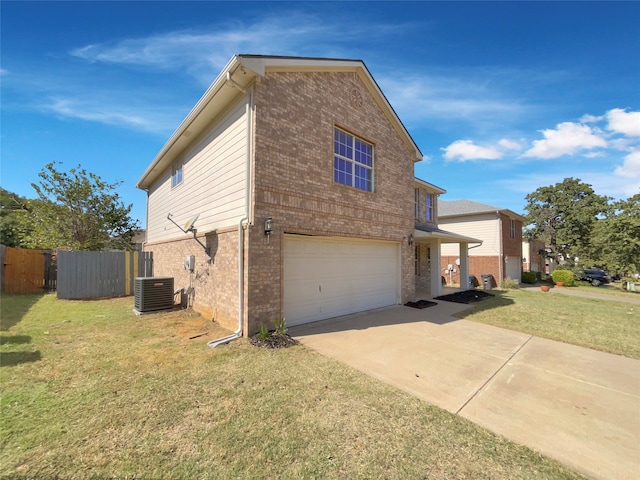 view of side of home with a garage, central air condition unit, and a lawn