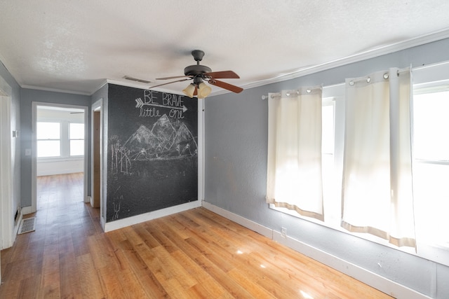 unfurnished room featuring ornamental molding, hardwood / wood-style flooring, and ceiling fan