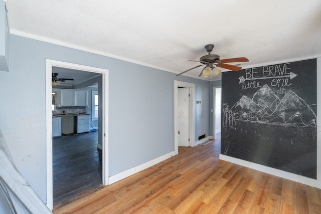 spare room with ceiling fan, hardwood / wood-style flooring, and ornamental molding