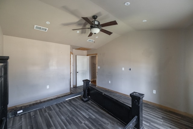 unfurnished bedroom featuring dark wood-type flooring, vaulted ceiling, and ceiling fan