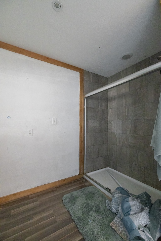 bathroom featuring a shower and hardwood / wood-style floors