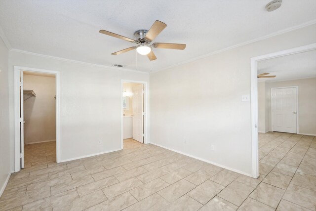 unfurnished room with ceiling fan and crown molding