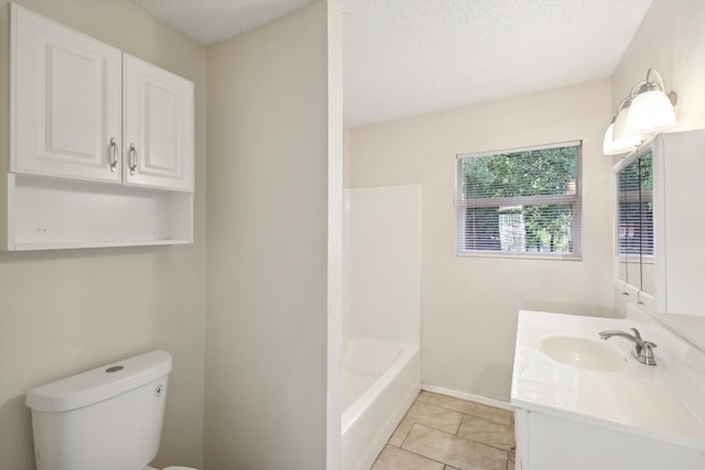 full bathroom featuring tile patterned floors,  shower combination, a textured ceiling, toilet, and vanity