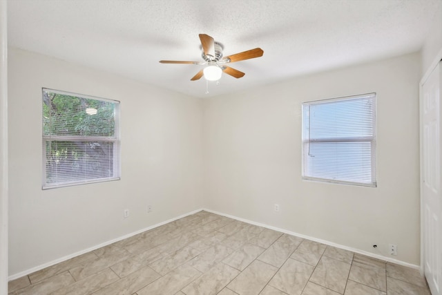 spare room featuring ceiling fan and a textured ceiling