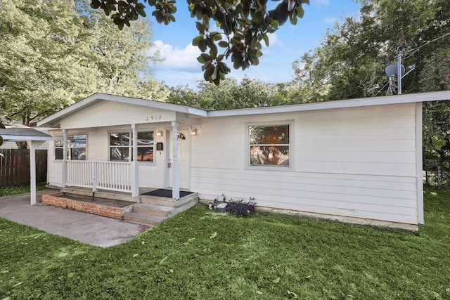 ranch-style house featuring a porch and a front lawn