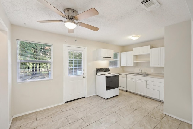 kitchen with white cabinets, white appliances, sink, and a textured ceiling