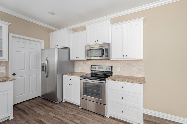 kitchen featuring white cabinets, tasteful backsplash, dark hardwood / wood-style flooring, ornamental molding, and stainless steel appliances