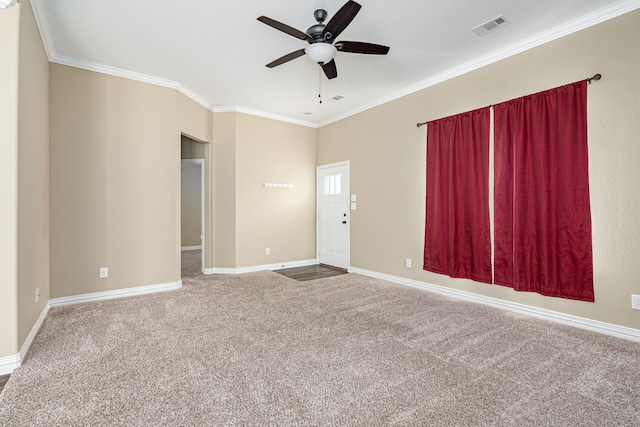 carpeted spare room with crown molding and ceiling fan