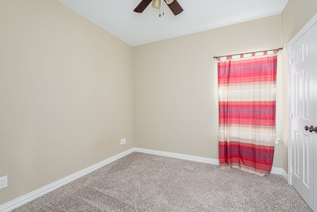 carpeted empty room featuring ceiling fan