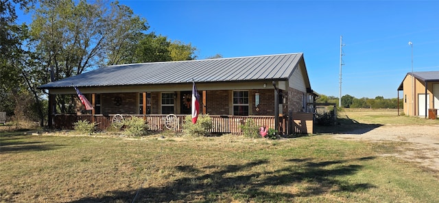 view of front of property with covered porch and a front lawn