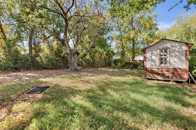 820 Allen St, Denton, TX 76205 - view of yard featuring a storage unit, a fenced backyard, and an outbuilding