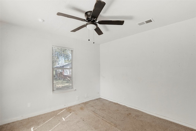 empty room featuring light colored carpet and ceiling fan