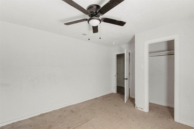 unfurnished bedroom featuring a closet, ceiling fan, and light colored carpet