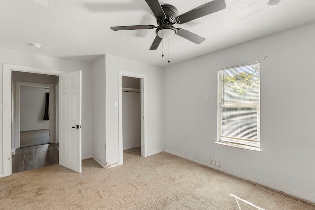 unfurnished bedroom with a closet, ceiling fan, and light colored carpet