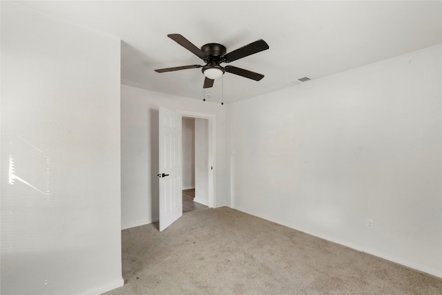 carpeted spare room with ceiling fan