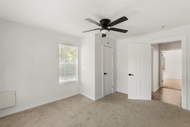 unfurnished bedroom featuring a closet, ceiling fan, and light carpet