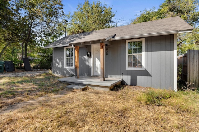 single story home with a front lawn and an outbuilding