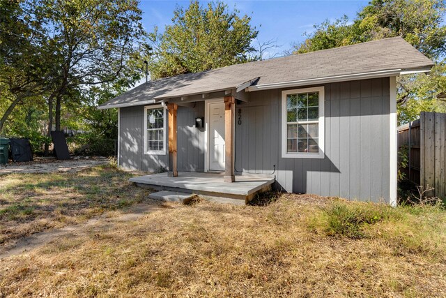 820 Allen St, Denton, TX 76205 - view of front of house with fence, an outbuilding, and roof with shingles