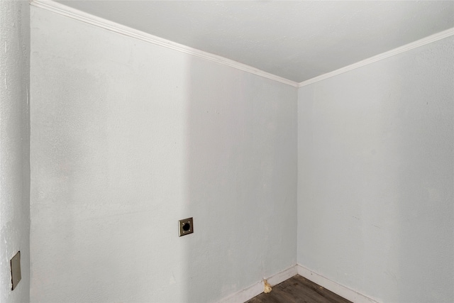 empty room with crown molding and dark hardwood / wood-style floors