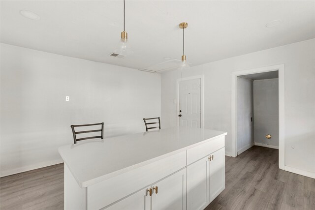 820 Allen St, Denton, TX 76205 - kitchen featuring light wood-style floors, light countertops, and white cabinets